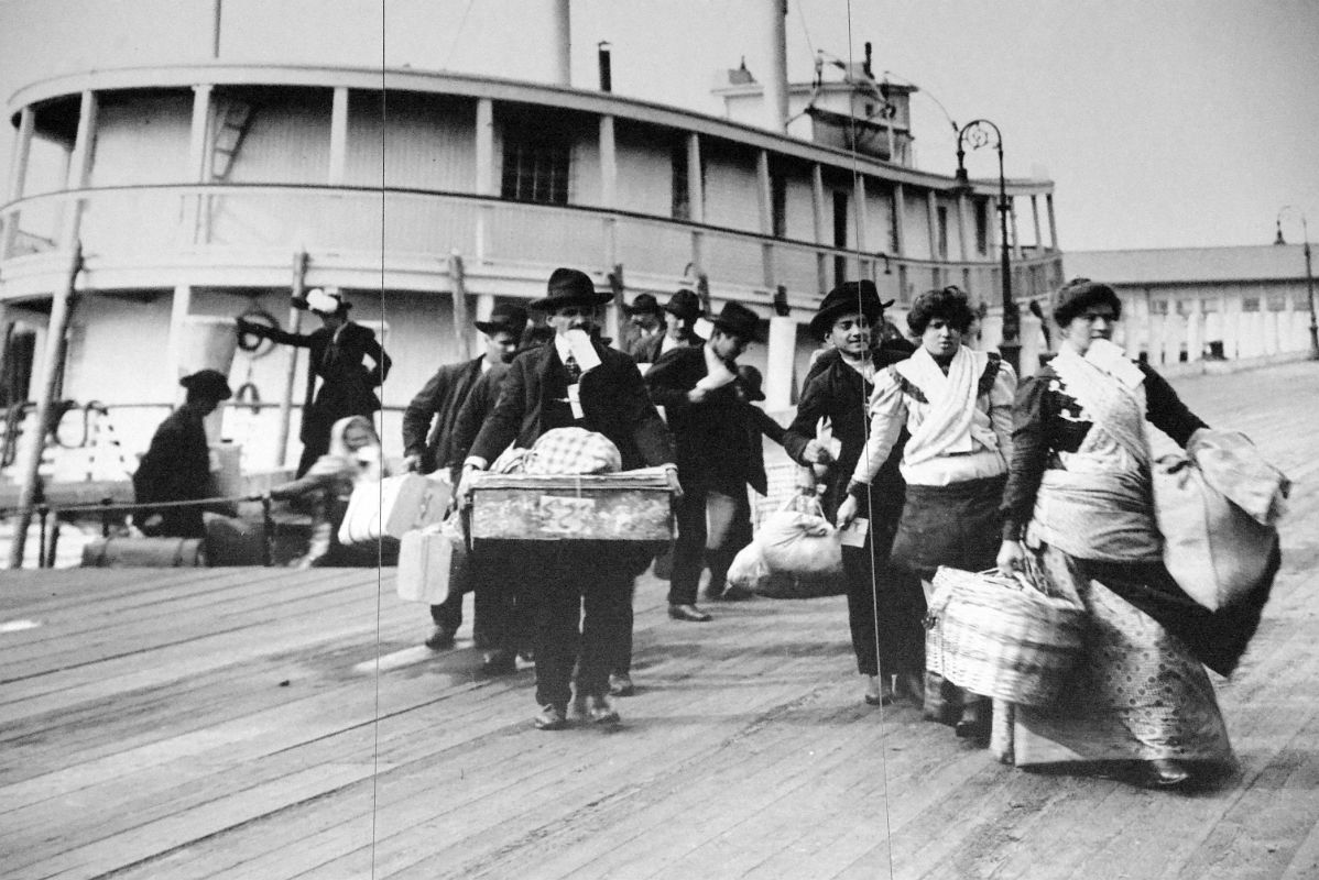 12-01 Photograph Of Immigrants Carrying Their Possessions In The Baggage Room Of Ellis Island Main Immigration Station Building